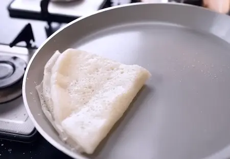 Cooking neer dosa on a dosa pan