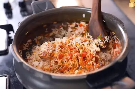 Adding basmati rice and water to the cooker