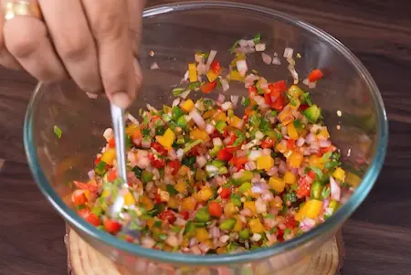 Mixing vegetables for Dahi Ke Sholey recipe stuffing mixture
