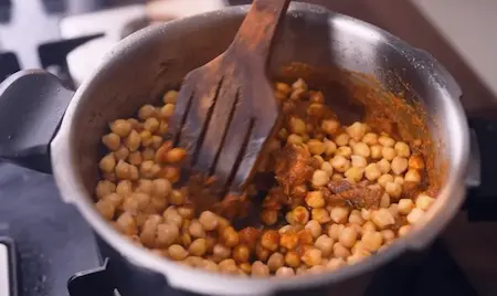 Step 2: Adding soaked kabuli chana, dry spices, baking soda and tea water for Peepé Wale Chole Kulche