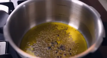 Step 3: Tempering whole spices in mustard oil for Pressure Cooker Mushroom Masala