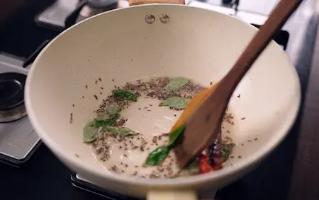 Step 4: Preparing tadka with mustard seeds and curry leaves for Masala Tendli Aloo
