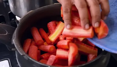 Carrots being sautéed in ghee for Cooker Wala Gajar Halwa