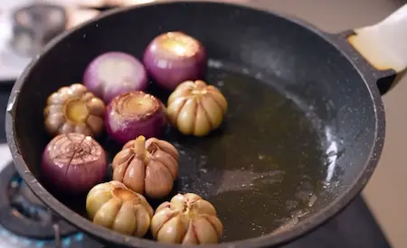 Onions being seared in a pan