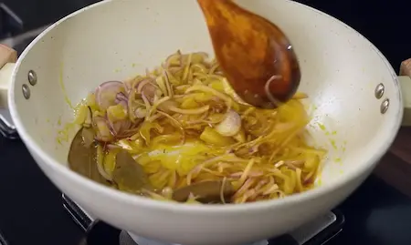 Step 5: Sauteing onions and ginger garlic for Creamy Pahadi-Style Rajma Madra Recipe