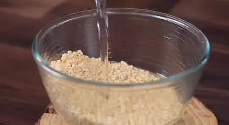 Grinding soaked urad dal into thick batter for Udid Daliche Vade recipe