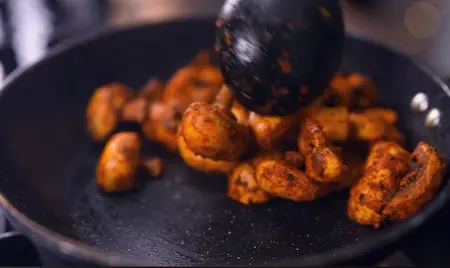 Step 2: Sautéing marinated mushrooms in butter for Pressure Cooker Mushroom Masala