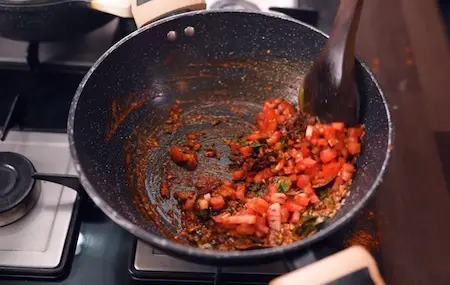 Adding Malvani masala sprouted vaal and potatoes to Vaal Chi Bhaji for Konkan Veg Thali