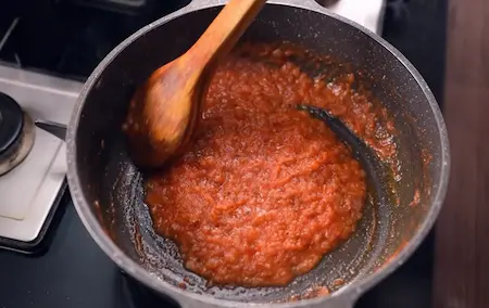 Step 4: Cooking tomato puree and green chillies for Soyabean Ki Sabzi