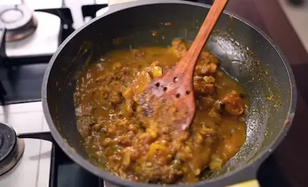 Step 4: Finishing the aloo sabzi with garam masala, hing water and fresh coriander for Aligarh Kachori