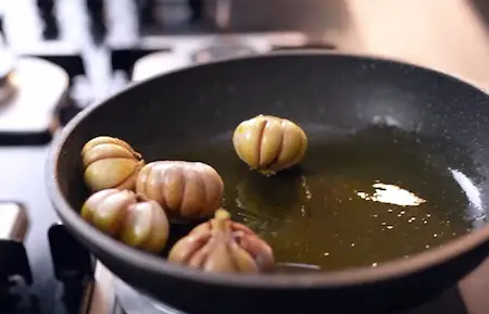 Garlic being fried in mustard oil