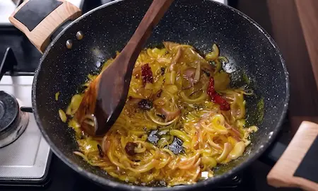 Step 3: sautéing whole spices and onions for Suran ki Sabji Recipe