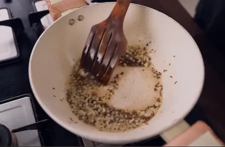 Step 2: Preparing tadka with mustard seeds, jeera and garlic for Bhujia Shing Ki Sabzi