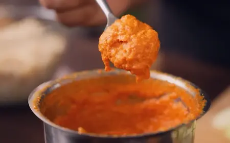 Blending raw mango fresh coconut turmeric and red chilli into smooth paste for Kairiche Raita