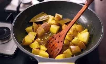 Step 2: Adding diced potatoes with skin to the pan for Aligarh Kachori Aloo Sabzi