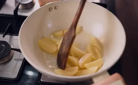 Step 1: Half-cooking potato wedges for Bhujia Shing Ki Sabzi