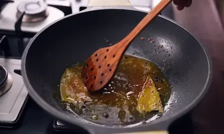 Step 1: Preparing the tempering with bay leaf, black pepper, jeera and turmeric for Aligarh Kachori Aloo Sabzi